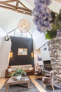 Maison Seignou في Azet: غرفة معيشة مع أريكة ومدفأة حجرية