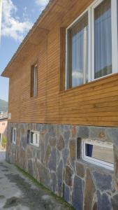 a stone building with two windows on the side of it at Guesthouse Mabu - 4 Newly Built Rooms in the Heart of Mestia in Mestia