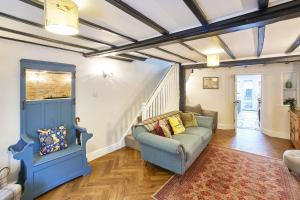 a living room with a couch and stairs at Host & Stay - Willow Cottage in Helmsley