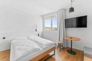 Ein Bett oder Betten in einem Zimmer der Unterkunft smartments Wien Heiligenstadt