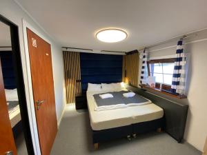 a bedroom with a bed and a window at Boat-Hostel "Marta" in Kraków