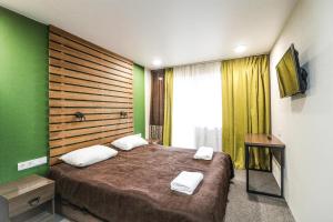 a bedroom with a large bed with green walls at Rancho Texas in Kurort Chemal