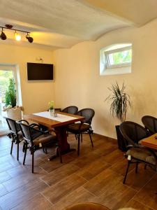 - une salle à manger avec une table et des chaises dans l'établissement Pension Villaggio, à Mertesheim
