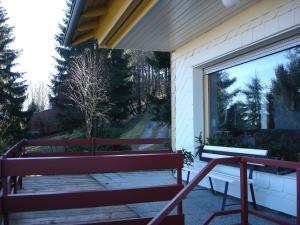 a bench on the side of a building with a window at Haus Brockenblick in Gehlberg