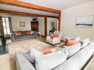 a living room with two couches and a couch at Church Barn in North Tawton