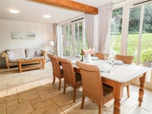 a dining room with a table and chairs at Church Barn in North Tawton