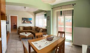 a living room with a couch and a table at Hawaii in Nea Michaniona