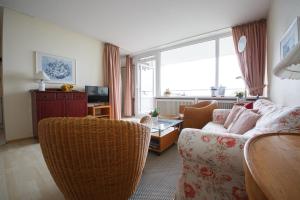 a living room with a couch and a window at Haus Uthlande Uthlande Whg 31 Traumblick in Wyk auf Föhr
