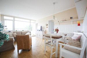 a kitchen and living room with a table and chairs at Oland Whg11 Sünnenkieker in Wyk auf Föhr