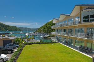 a large building with a yard in front of a marina at Beachcomber Inn Picton in Picton