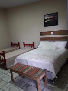 En eller flere senge i et værelse på Pousada DuBaldo