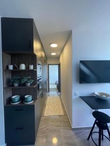 a kitchen with a table and a dining room at Hello 3B Apartman in Keszthely