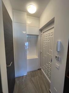 a hallway with a door and a walk in shower at Hello 3B Apartman in Keszthely