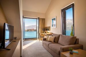 a living room with a couch and a large window at Aminess Liburna Hotel in Korčula