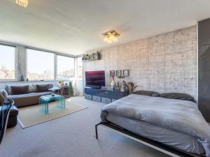 a bedroom with a bed and a brick wall at Pass the Keys Cosy 1 Bedroom Studio Apartment in Belsize Park in London