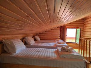 a bedroom with two beds in a wooden room at Old Tbilisi Villa Costa in Tbilisi City