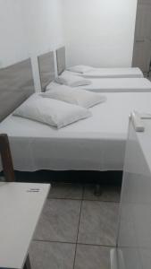 Tempat tidur dalam kamar di Porto Seguro Hotel - Porto Velho