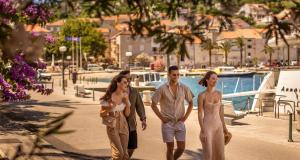 a group of three people walking down a sidewalk at Aminess Younique Korcula Heritage Hotel in Korčula