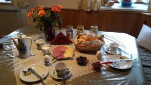 a table with a bowl of fruit and a basket of eggs at Gästehaus Frankl in Rottau