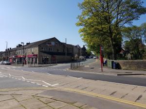 an empty street in a town with a building at Golden Plover at Plover Cottage Lindley in Huddersfield