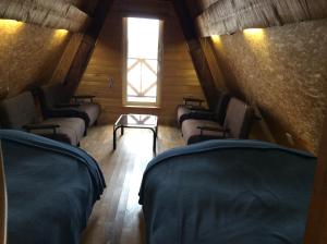 a room with rows of chairs and a window at Woody Life in Kami-furano