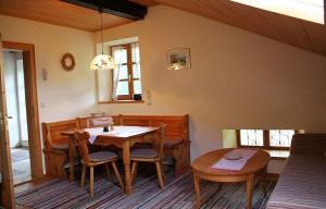 a dining room with a wooden table and chairs at Jaklhof in Frasdorf
