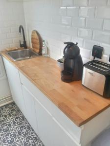 a kitchen counter with a sink and a microwave at Anna's Home Sweet Home in Boulogne-Billancourt