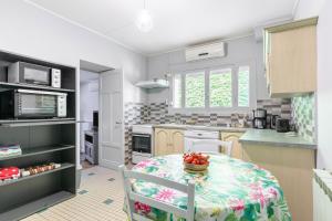 a kitchen with a table with a bowl of fruit on it at Ombrelle in Le Pian-sur-Garonne