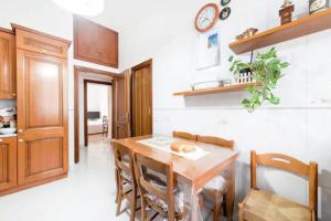 a kitchen with a table and chairs in a room at La Risorgente B&B in Rome
