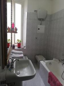 a bathroom with a sink and a tub and a toilet at La Risorgente B&B in Rome