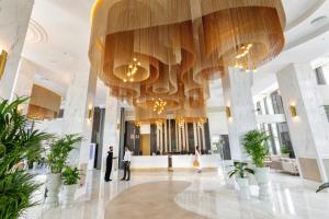 a lobby of a building with a large chandelier at Hotel Riu Palace Maspalomas - Adults Only in Maspalomas