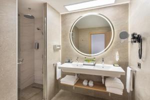 a bathroom with a sink and a mirror at Hotel Riu Palace Maspalomas - Adults Only in Maspalomas