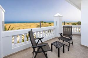 a balcony with two chairs and a view of the ocean at Hotel Riu Palace Maspalomas - Adults Only in Maspalomas