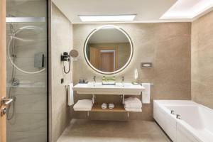 a bathroom with a sink and a mirror at Hotel Riu Palace Maspalomas - Adults Only in Maspalomas