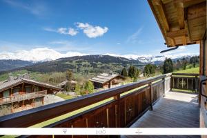 a balcony of a house with a view of mountains at Les Belles Cimes in Combloux