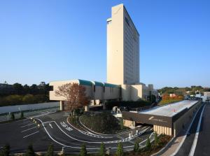a large white building with a road in front of it at Hotel Concorde Hamamatsu in Hamamatsu