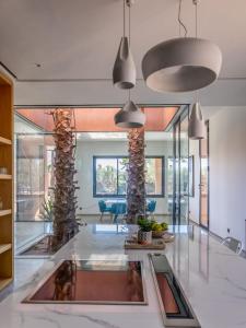 a living room with glass walls and a lobby at Villa familiale aux portes de Marrakech in Marrakesh
