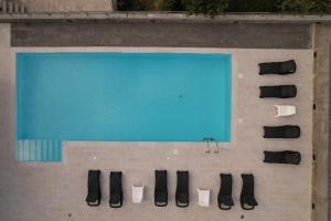 a large swimming pool with black shoes on the ground at Quinta dos Castanheiros - Turismo Rural in Negreda