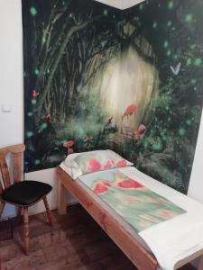 a bedroom with a painting of a forest at Ferienwohnung Familie Faath in Bellheim