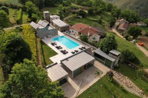 an aerial view of a house with a swimming pool at Quinta dos Castanheiros - Turismo Rural in Negreda