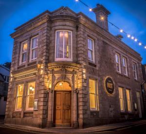 an old brick building with a star on top at Host St Ives in St Ives