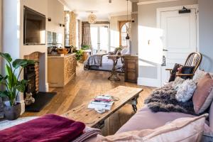 a living room with a couch and a table at Host St Ives in St Ives