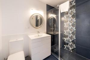 a bathroom with a white sink and a mirror at Moonkey - Casa Toledo in Alicante