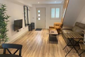 a living room with a couch and a tv at Apt 3 Silver Spruce - Killarney Town Free Parking in Killarney