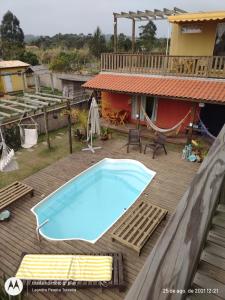 a swimming pool on the deck of a house at Morada Betel Box in Praia do Rosa