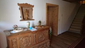 een kamer met een houten dressoir en een trap bij Landhaus Eberler in Mayrhofen