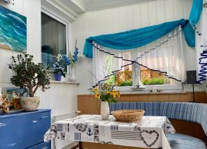 a table with a table cloth on it with a window at Haus Steffine in Annahütte