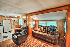 a living room with a couch and a chair at Higden Hideaway on Lake Pets and ATVs Allowed! in Fairfield Bay