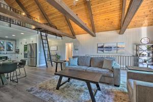 a living room with a couch and a table at Airy Alpine Getaway with Lake Arrowhead Views! in Lake Arrowhead