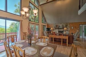 a dining room with a table and chairs and a living room at Mountain Retreat with Decks, Hot Tub, and Games! in Sky Valley